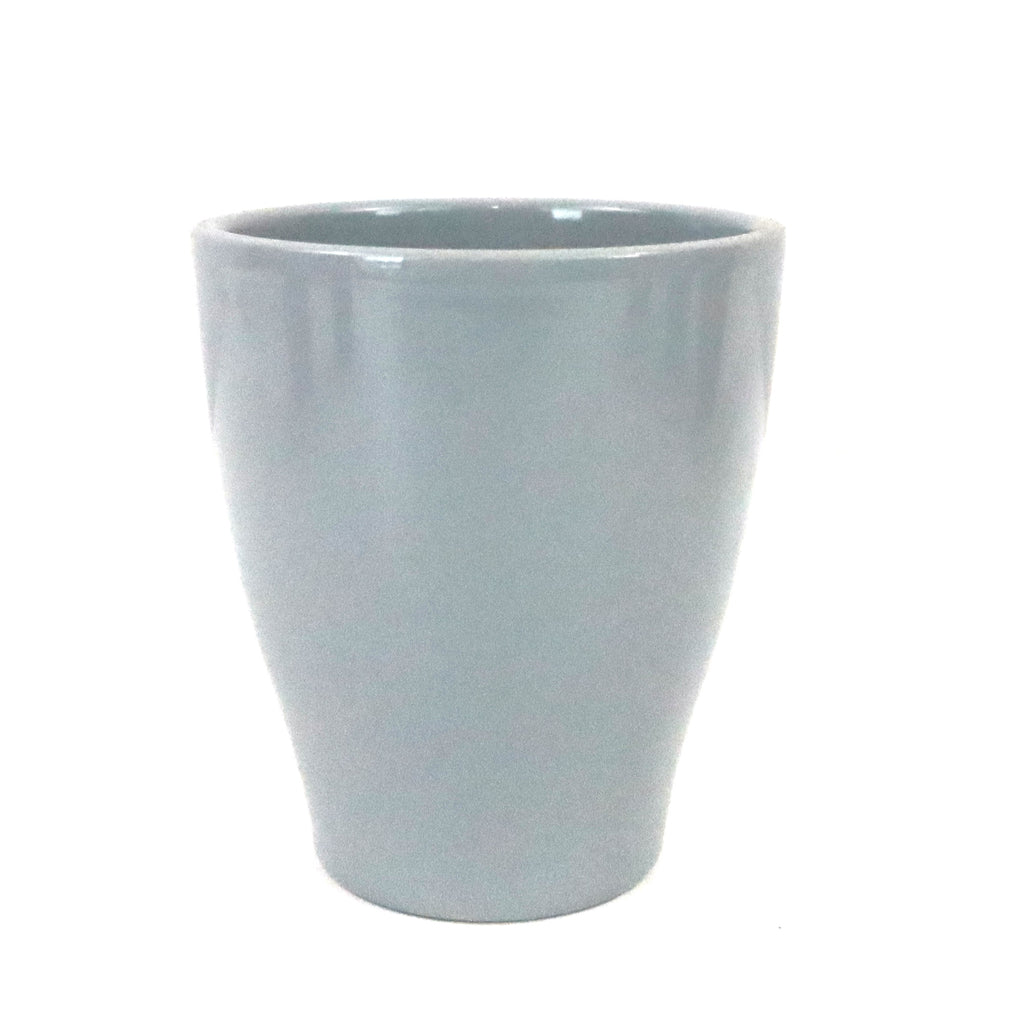 A glossy white ceramic pot sits on a white background, highlighting the simple and stylish design of classic pottery.