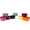 Nine ceramic garden bowls in pink, purple, black, blue, white, yellow, orange, red, and green are stacked on a white background.