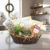 The 2 Succulent Growing Kit Gift Basket on a kitchen counter with potted plants, care guides, a Merry Christmas card, and holiday decor.